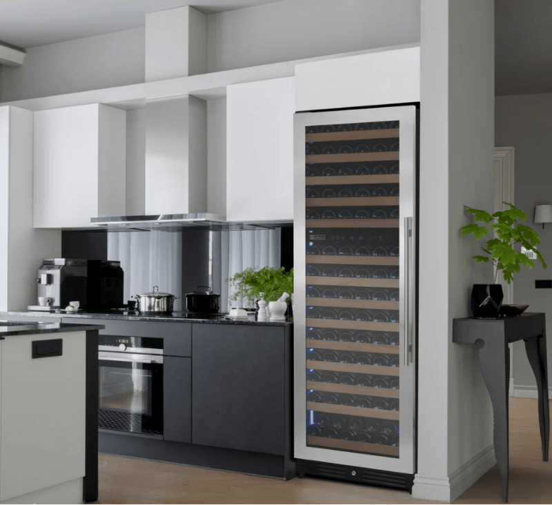 Modern kitchen with a wine cooler next to a stove and cabinets.