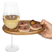 TOSCANA ENTERTAINING WINE AND APPETIZER PLATE, SET OF 4, IN ACACIA WOOD-showing s hand holding an appetizer/wine tray with a full glass of wine on a white background.