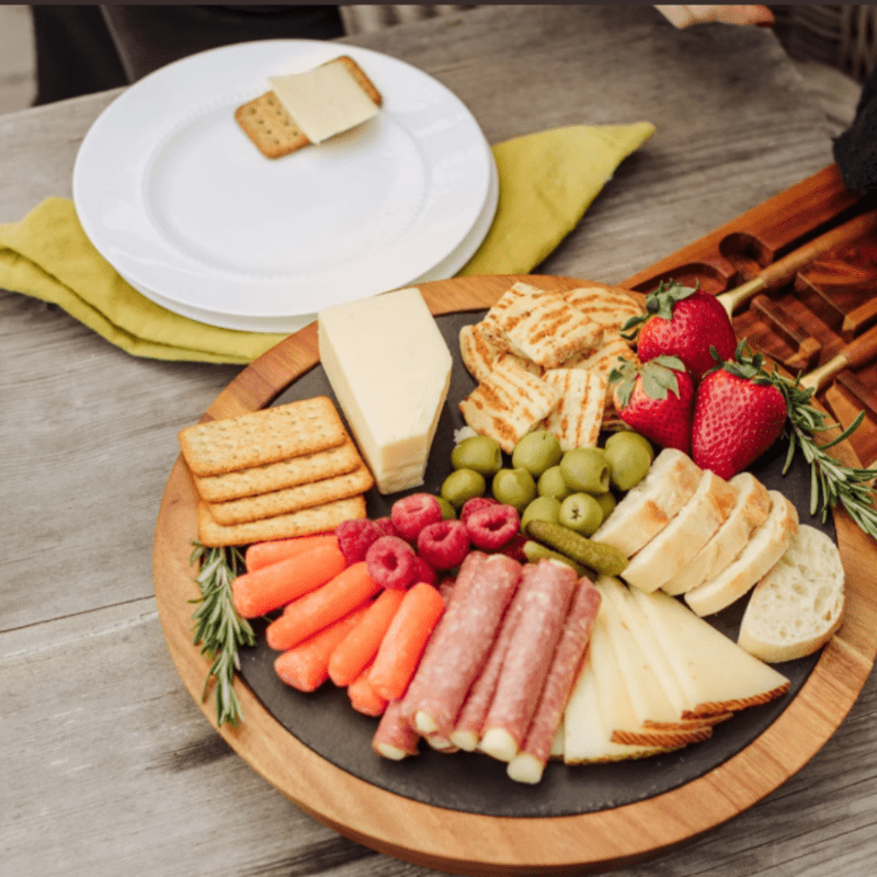 INSIGNIA ACACIA AND SLATE SERVING BOARD WITH CHEESE TOOLS-serving board full with appetizers