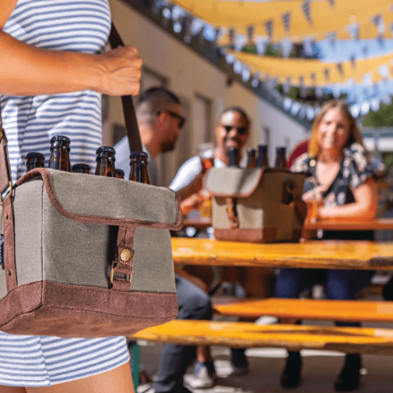 Legacy Barware Beer Caddy Cooler Tote With Opener - Khaki Green with Brown Accents - woman outside carrying tote over her shoulder