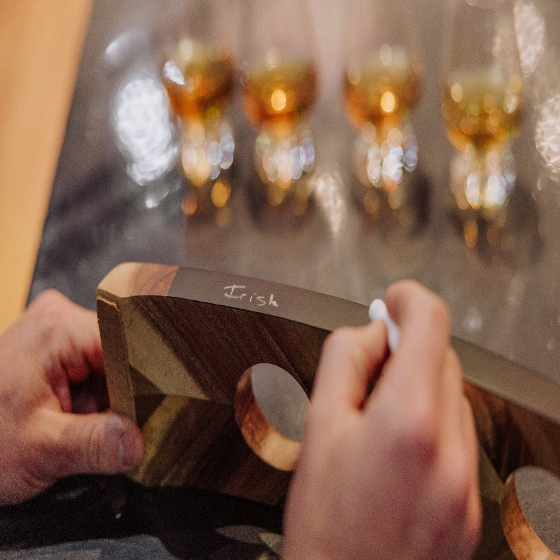 Legacy Lowlands Whiskey Flight Tasting Set - person writing in chalk the type of whiskey