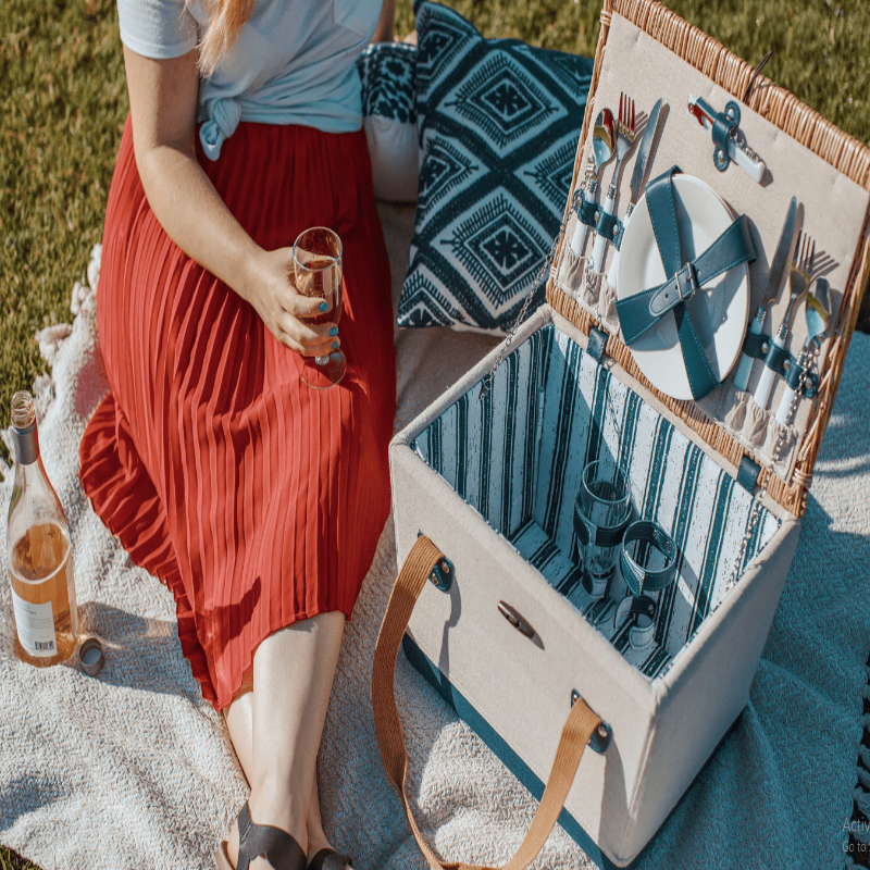 Picnic Time Boardwalk Picnic Basket for 2 - Woman drinking wine beside the Picnic Basket