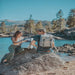 Picnic Time Frontier Picnic Backpack - man and woman on rock by lake with backpack 