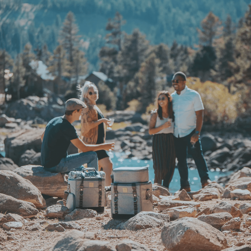 Picnic Time Frontier Picnic Utility Cooler - Perfect for outdoor picnic, two men and two women beside a lake