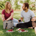 Picnic Time Malibu Frontier Edition Picnic Basket Cooler - Couple uses the picnic bag outdoors 