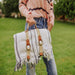 Picnic Time Montecito Picnic Blanket with Harness - White & Blue Stripe - woman holding blanket by the harness