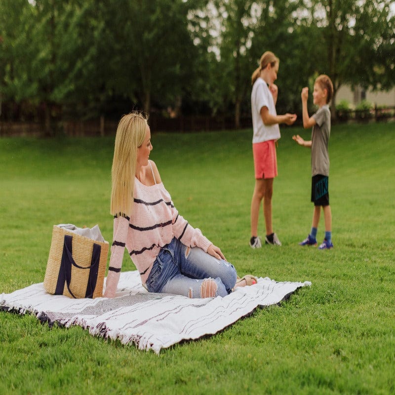 Picnic Time Montecito Picnic Blanket with Harness - White & Blue Stripe - women on blanket with kids playing