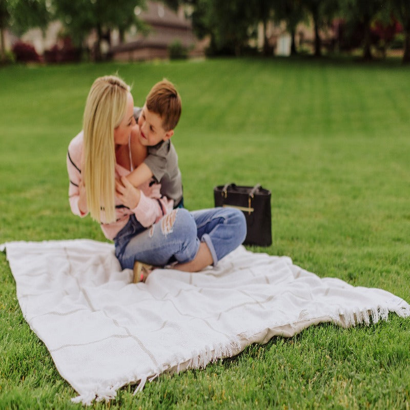 Picnic Time Montecito Picnic Blanket with Harness  - woman and boy on the blanket