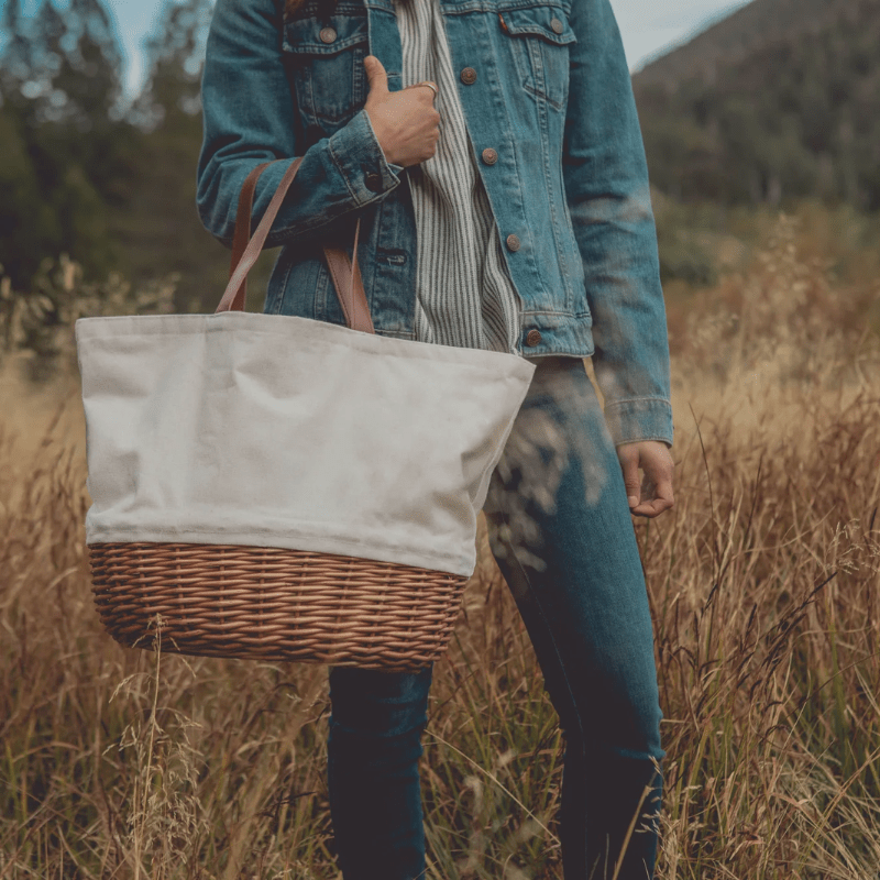 Picnic Time Promenade Picnic Basket - Beige Canvas - Woman using the picnic bag basket outside