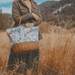 Picnic Time Promenade Picnic Basket - Floral Pattern - Woman using floral picnic basket outside