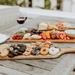 Toscana Artisan 24 Acacia Charcuterie Board - Pastries on the top of cutting board