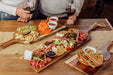 Toscana Set of 3 Artisan Serving Planks - people holding wine glasses and appetizers on the planks