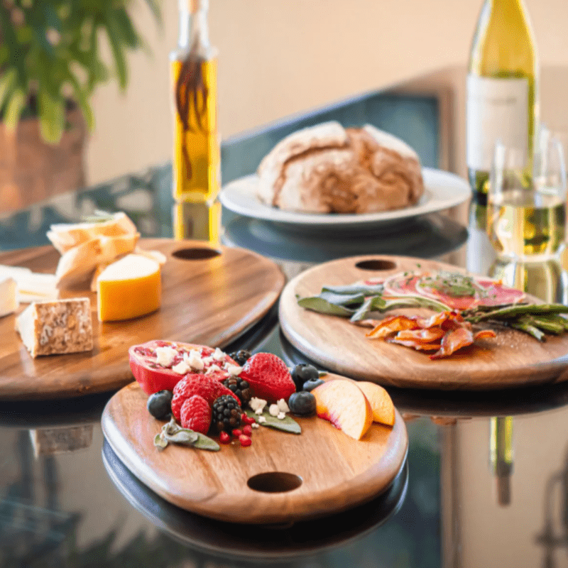 Toscana Set of 3 Pebble Shaped Acacia Serving Boards - boards with cheese and fruit and a bottle of white wine