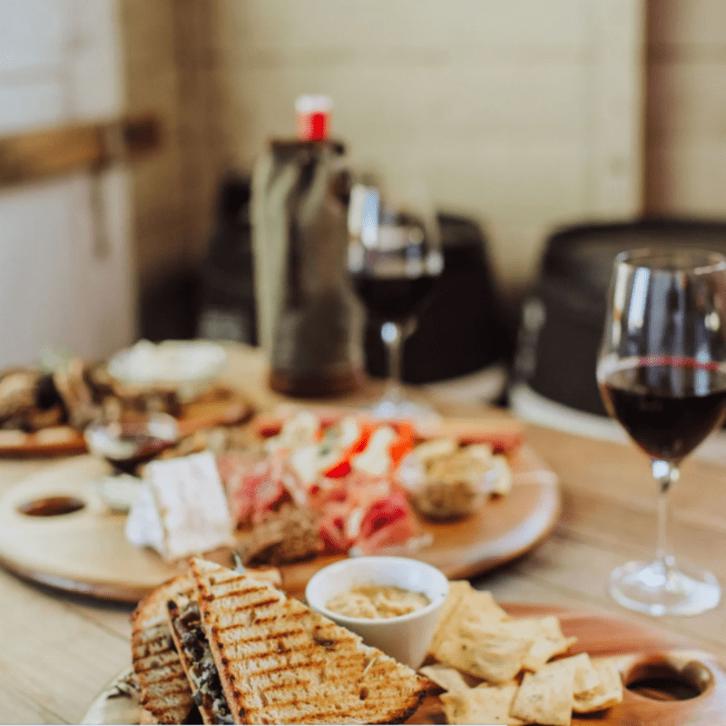 Toscana Set of 3 Pebble Shaped Acacia Serving Boards - boards on a dining table with glasses of red wine