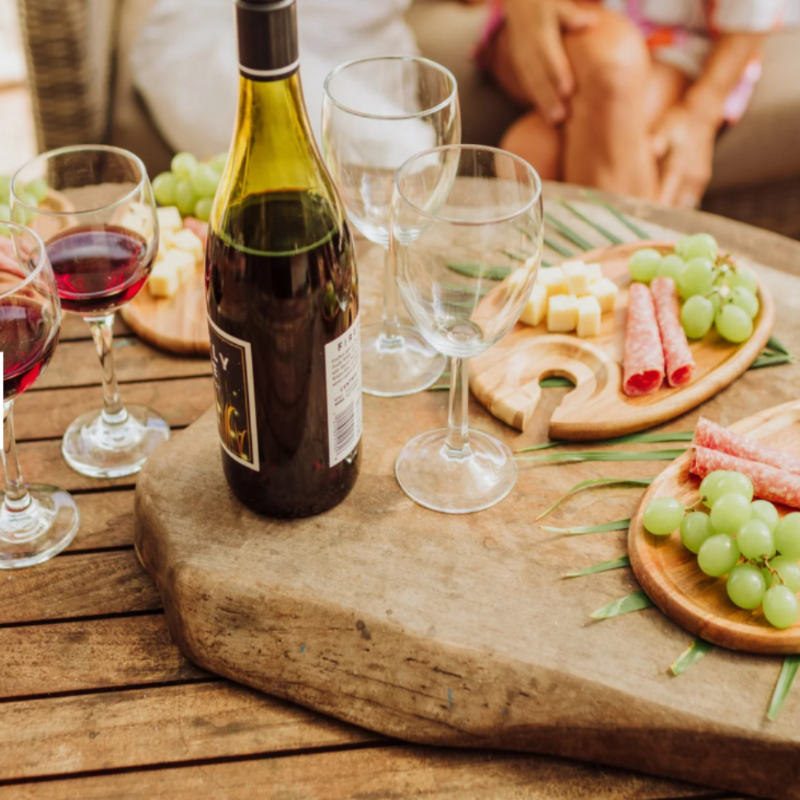 TOSCANA ENTERTAINING WINE AND APPETIZER PLATE, SET OF 4, IN ACACIA WOOD-showing an appetizer tray with an empty wine glass next to it.